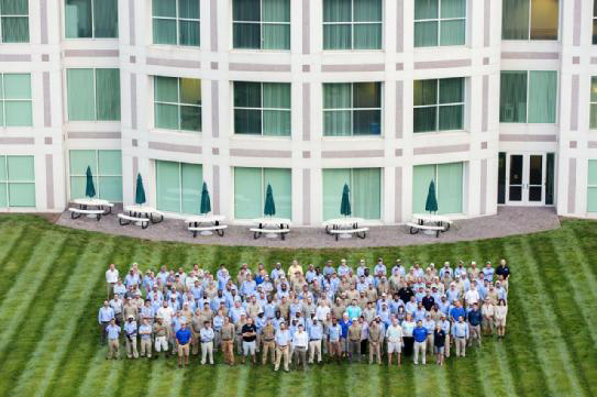 The Bland crew lined up on freshly manicured turfgrass outside an office building