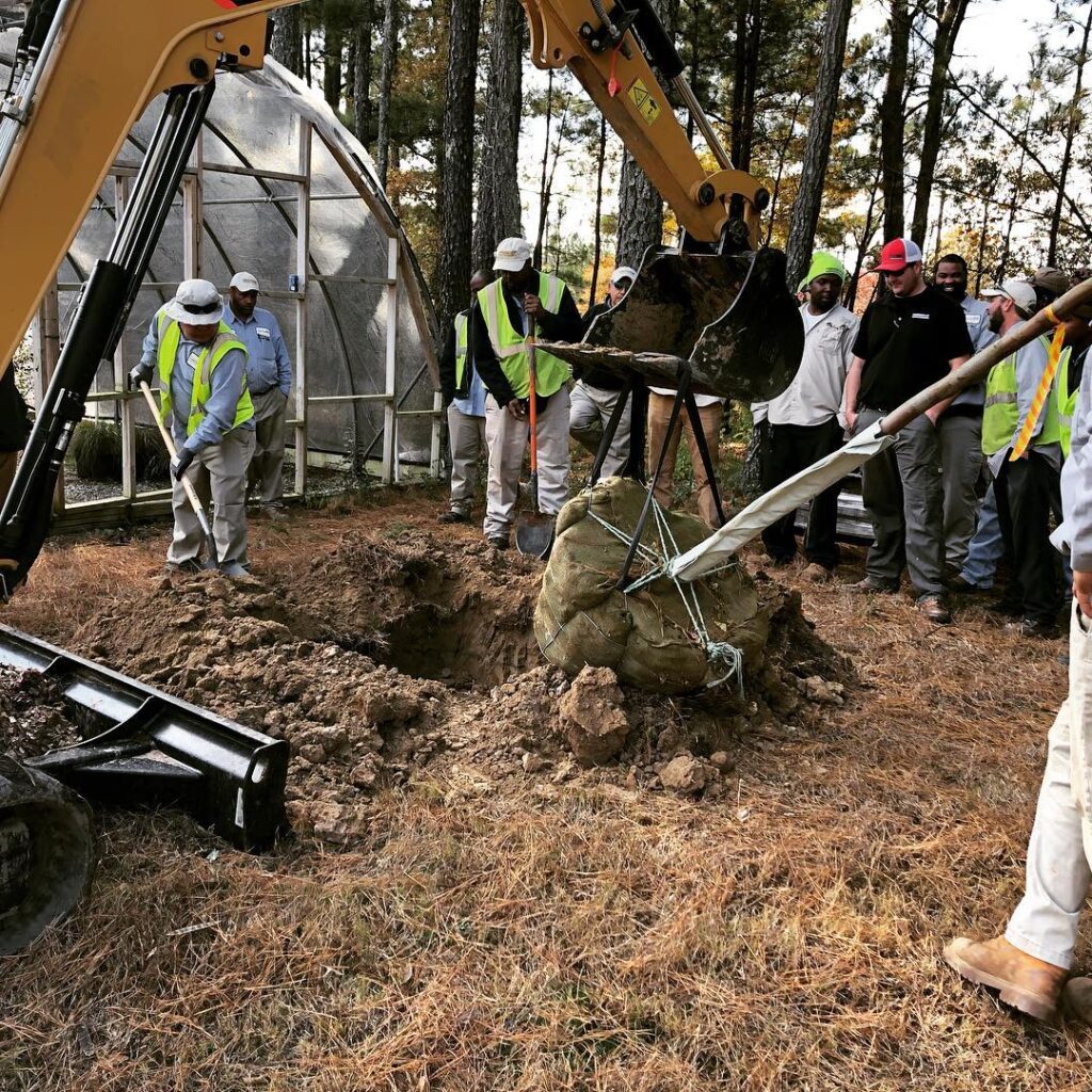 The Bland crew receives forklift training outside a greenhouse