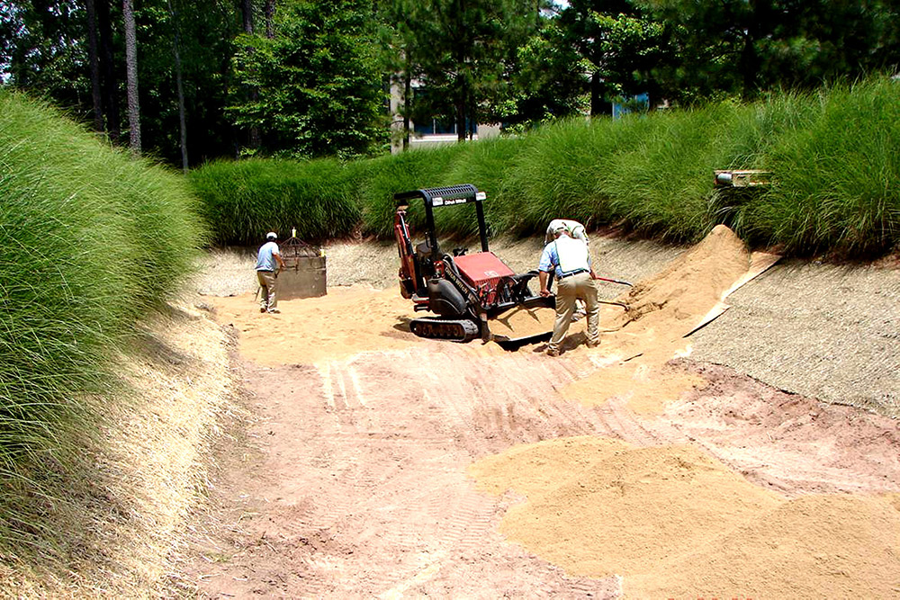 The Bland crew prepares for stormwater by digging a large ditch