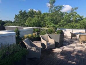 A rooftop garden area with seating.
